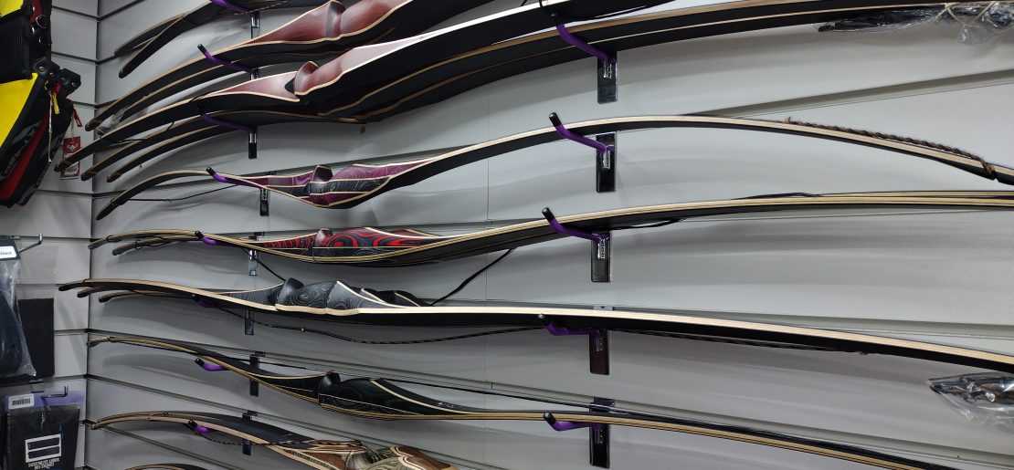 A selection of American flat bows as displayed in the shop at Indigo Archery